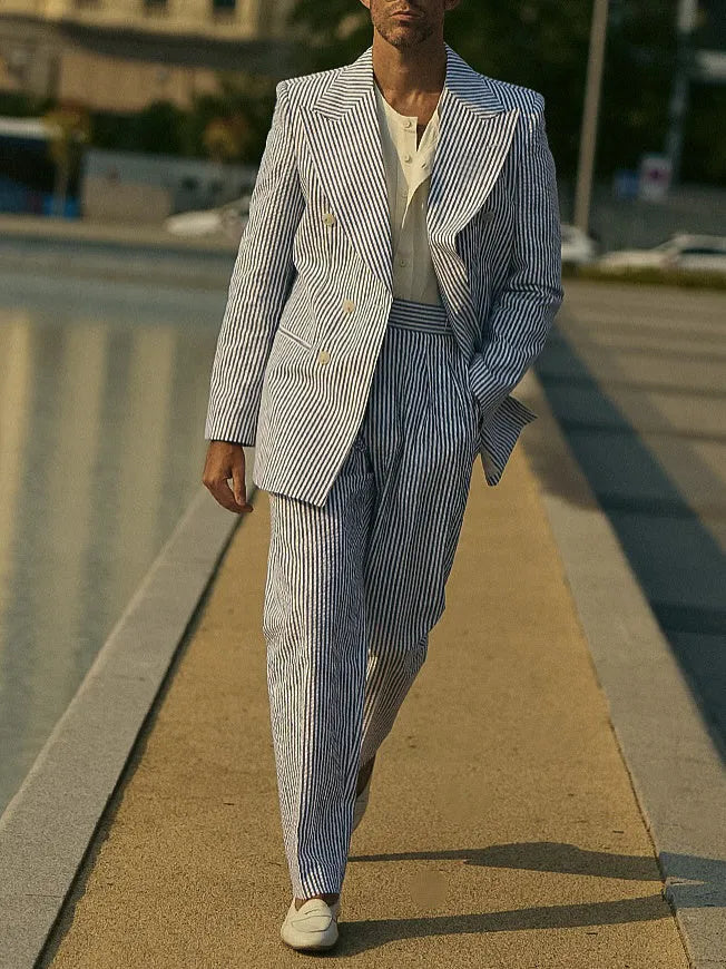 Blue and white striped polyester blazer and trousers suit set on a hanger