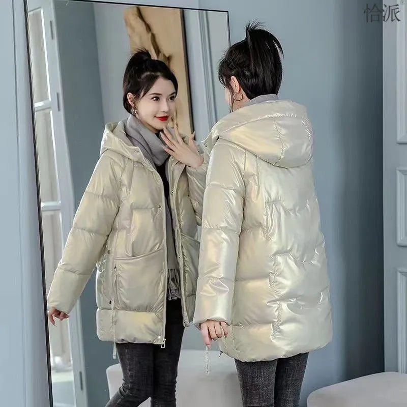 Green loose-fit hooded winter jacket for women on a hanger, showing long sleeves.
