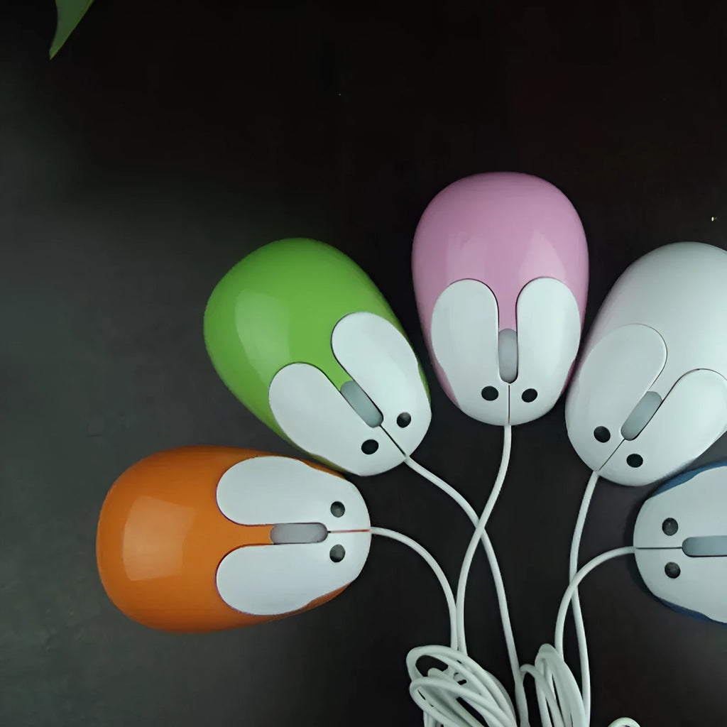 Pink wired rabbit mouse on desktop with USB cable and scroll wheel