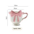 Ceramic mug with a cute girl heart bow design in black pink and white powder colours.