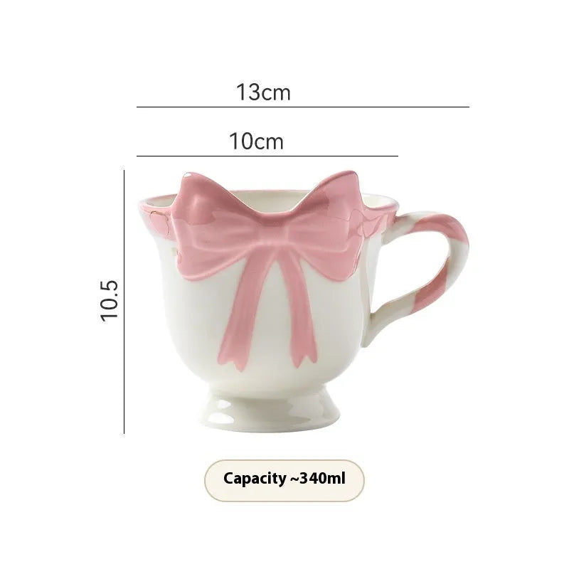 Ceramic mug with a cute girl heart bow design in black pink and white powder colours.