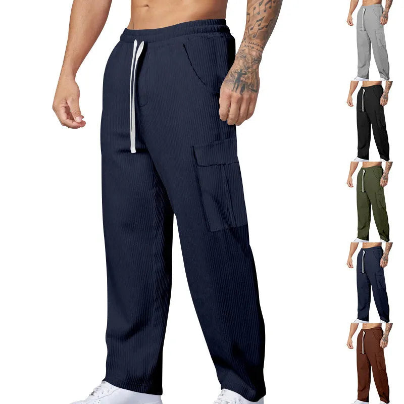 Men's navy blue corduroy cargo trousers with a drawstring waist and straight legs laid flat.