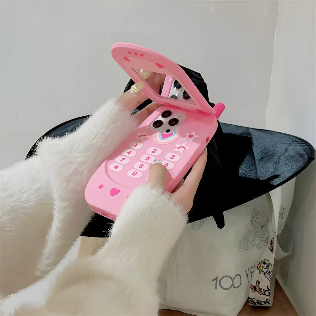 Light pink silicone flip phone case with a mirror, shown next to a rose red version, for iPhone models.