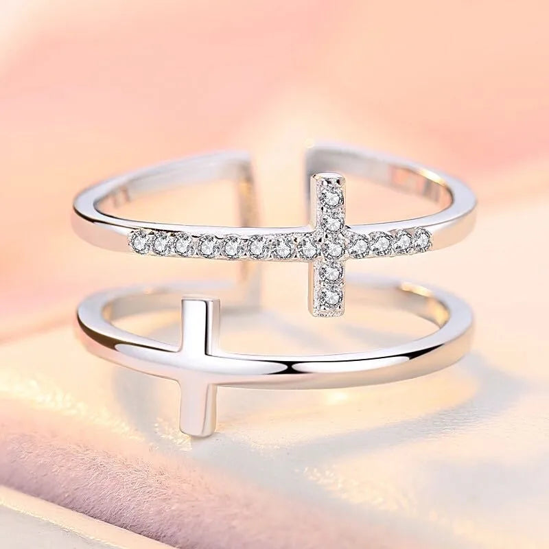 Adjustable double cross geometric ring in white gold colour with zircon stones in a sterling silver inlay.