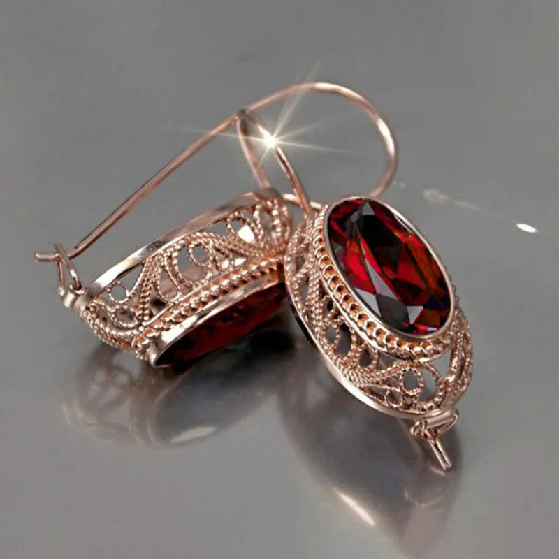 Women's copper and glass geometric earrings in red and blue with ellipse and ring shapes