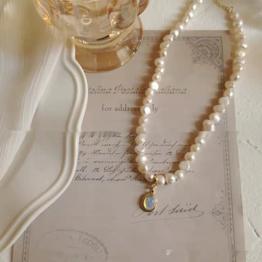 Adjustable French vintage style pearl necklace with geometric links on a white background.