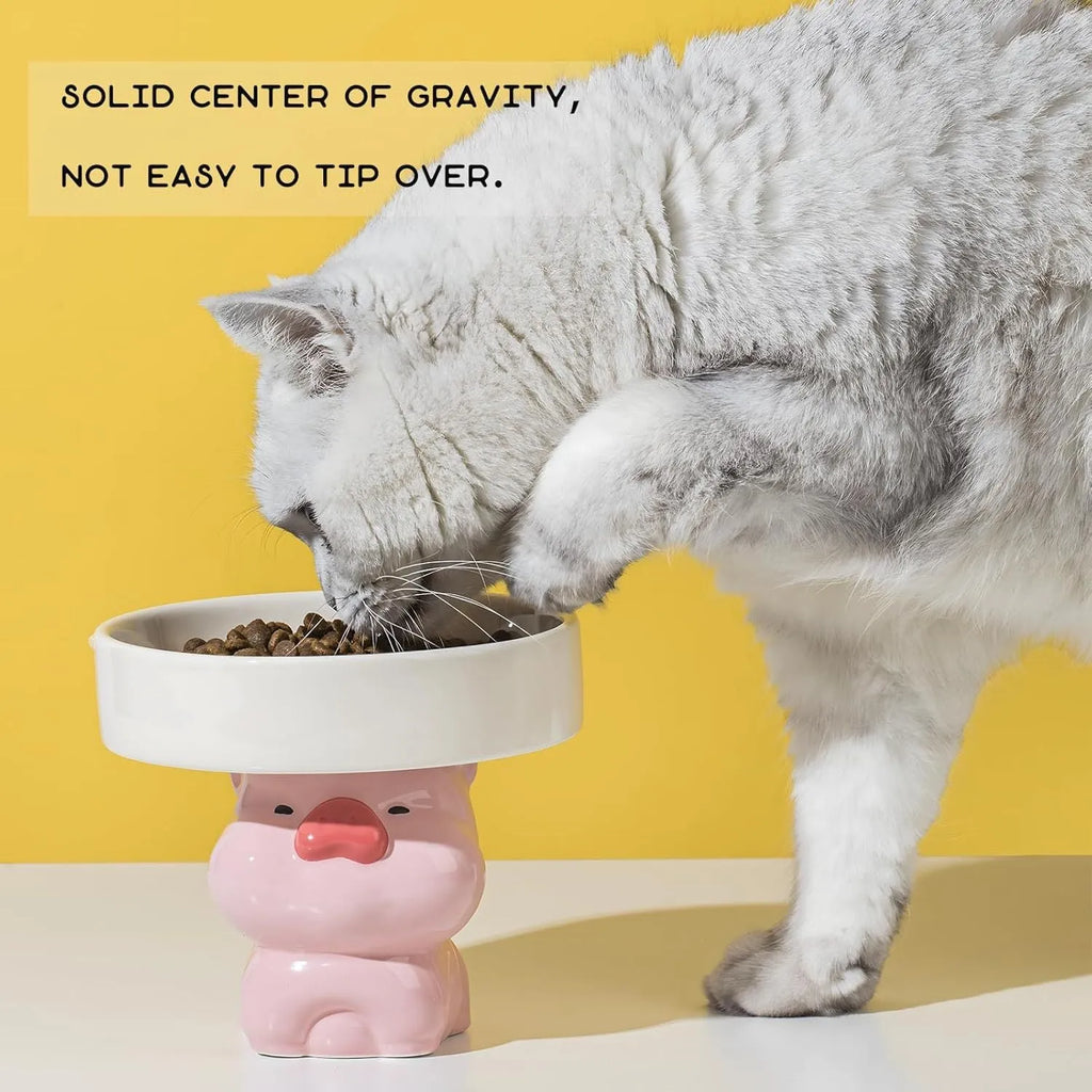 Raised ceramic cat bowl with animal design in pink, yellow, or white, showing wide rim.