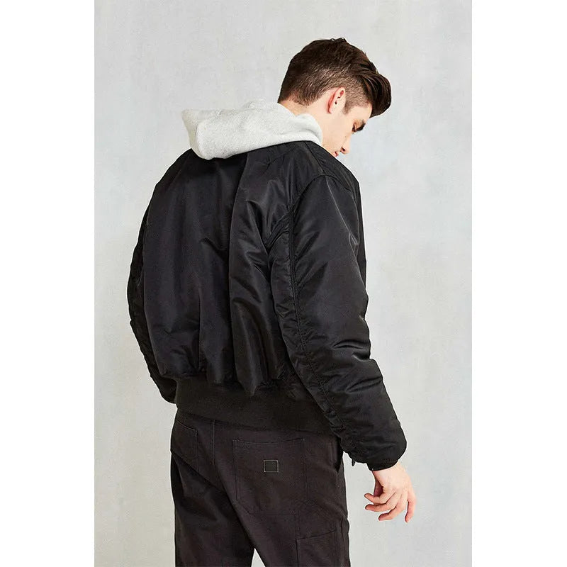 Men's loose fit army green cotton-padded pilot jacket on a hanger.