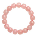 Pink natural crystal bracelet with barrel-shaped 8x10mm beads in a geometric design.