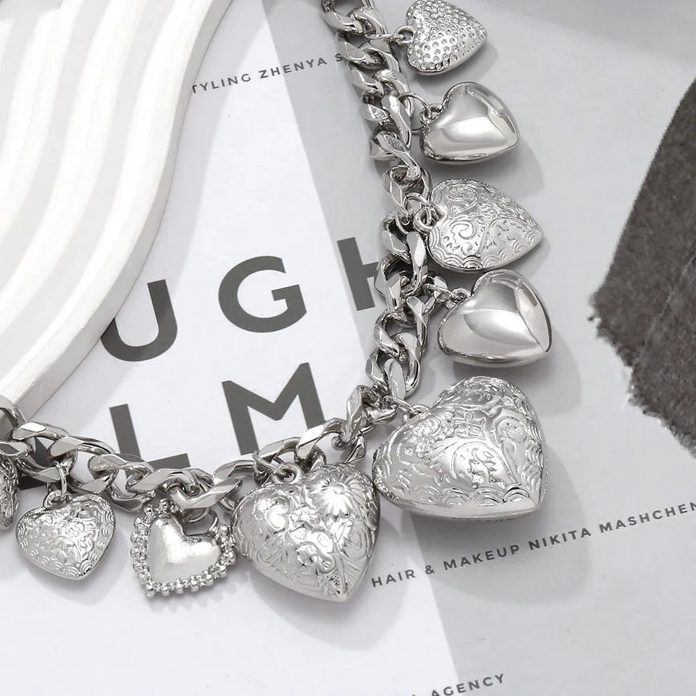 Exaggerated carved heart-shaped pendant necklace on an adjustable metal chain, shown in a gold colour finish.