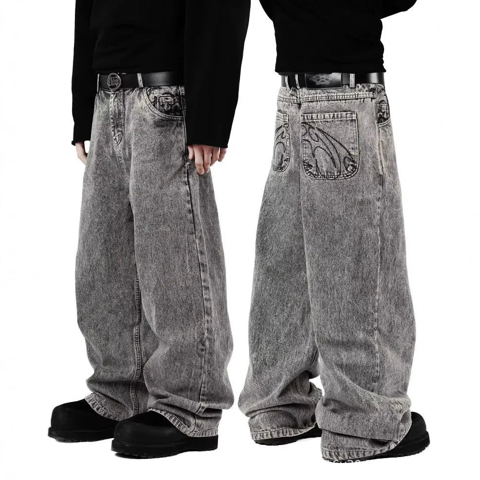 Grey loose straight-leg denim trousers for men and women laid flat, showing mid waist and classic cut.