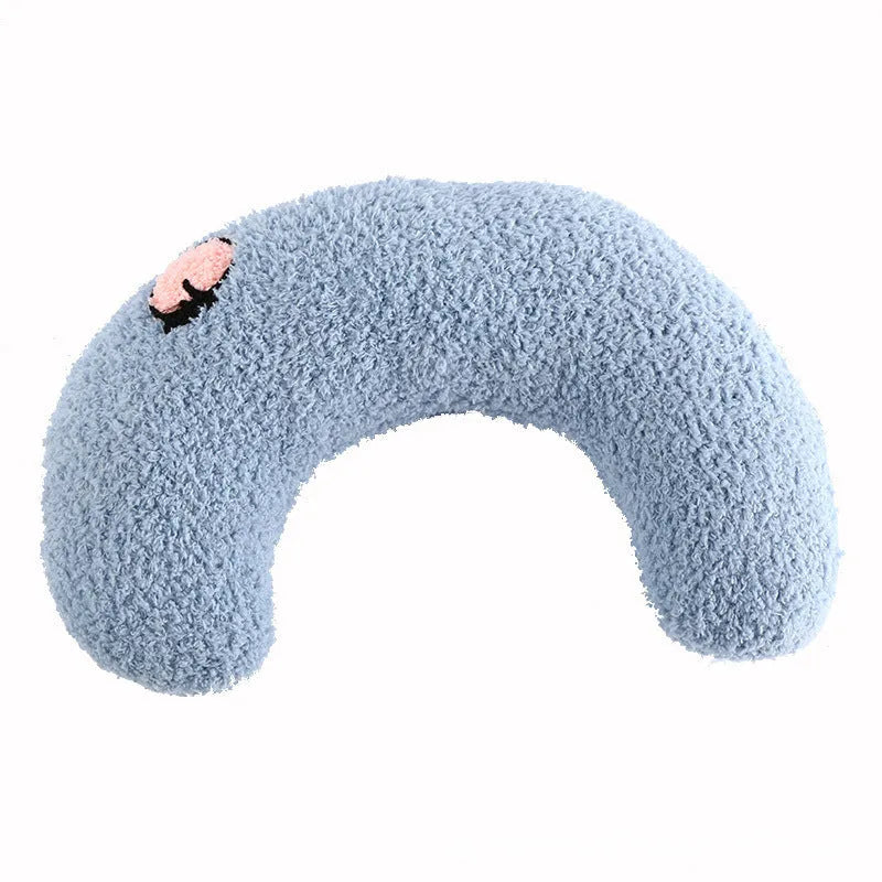 White U-shaped plush pet pillow for a cat, showing its donut shape and quilted texture.