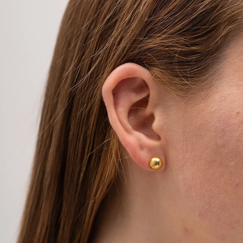 Stainless steel ball stud earrings with gold or silver electroplating in minimalist geometric design.
