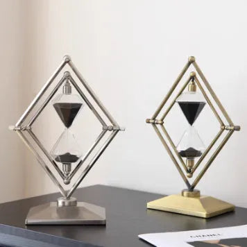 Glass sand timer with zinc alloy metal ornaments showing bronze or silver finish with white or black sand
