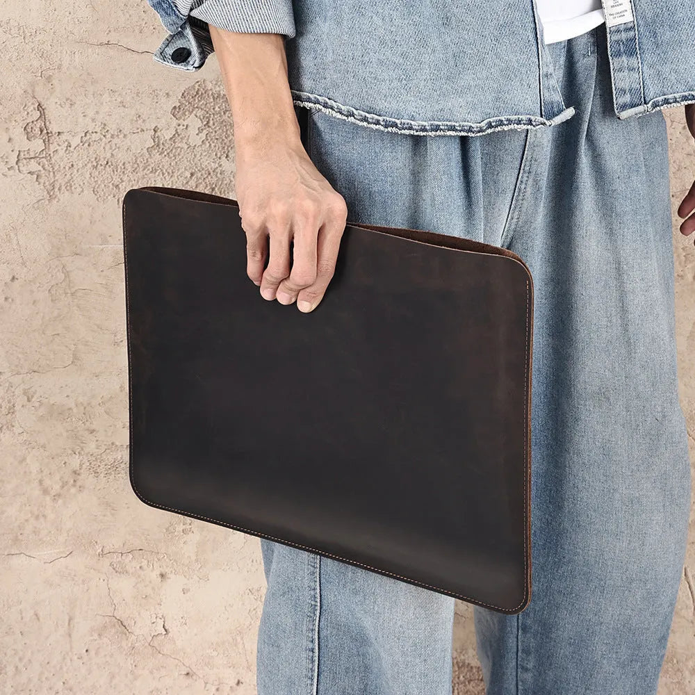 Men's brown Crazy Horse leather horizontal computer liner bag with compartments.