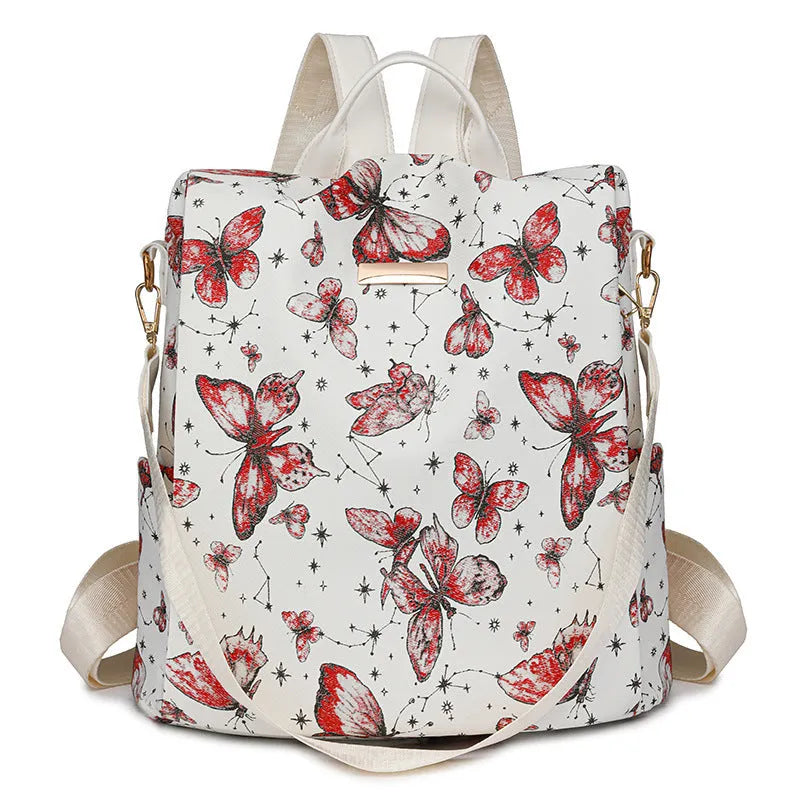 Butterfly print PU leather backpack in purple shown from the side, featuring sewing line details and shoulder straps.