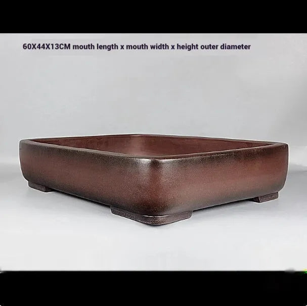 Handmade rectangular purple clay flower pot on a tabletop