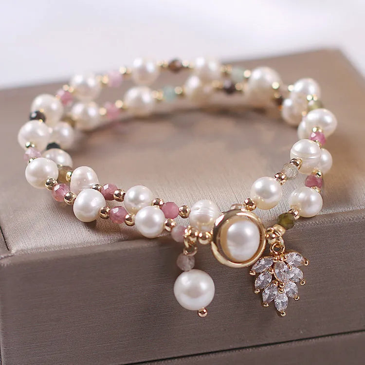 Women's double layer Strawberry Quartz crystal bracelet with Lucky Cat charm and red cat's eye flowers.