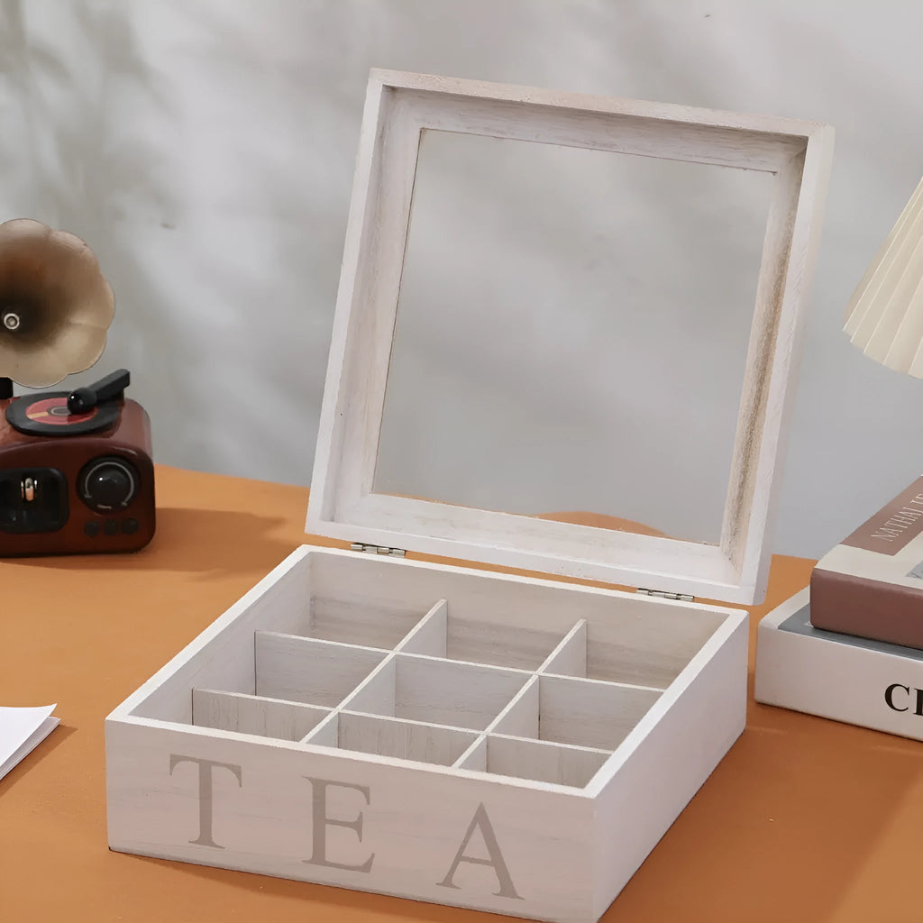 White wooden multi-grid coffee storage box with transparent cover on a desk