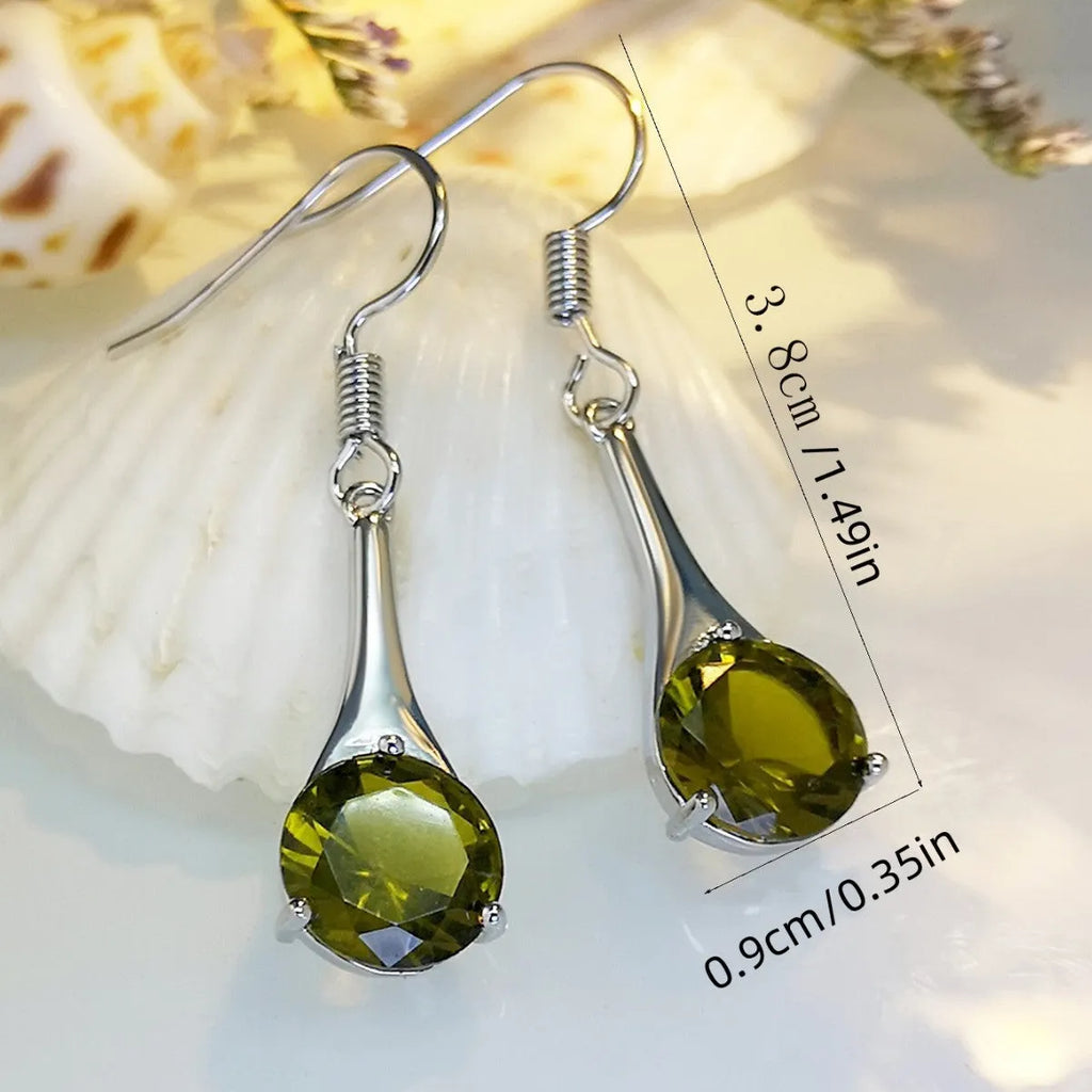 Olive green topaz coloured water drop shape earrings with minimalist retro styling on white background