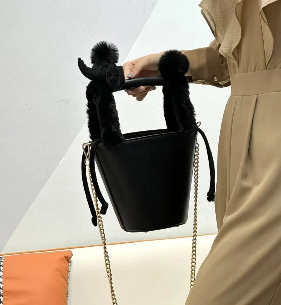 Women's PU messenger crossbody bag in black with urban simplicity style, placed on a flat surface