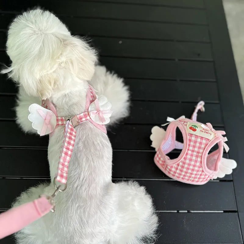 Pink adjustable cotton dog harness with chest and back handle on a small dog.