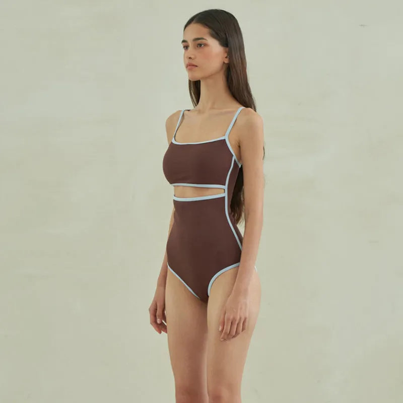 Brown women's one-piece swimsuit with triangle halter neck on a mannequin.