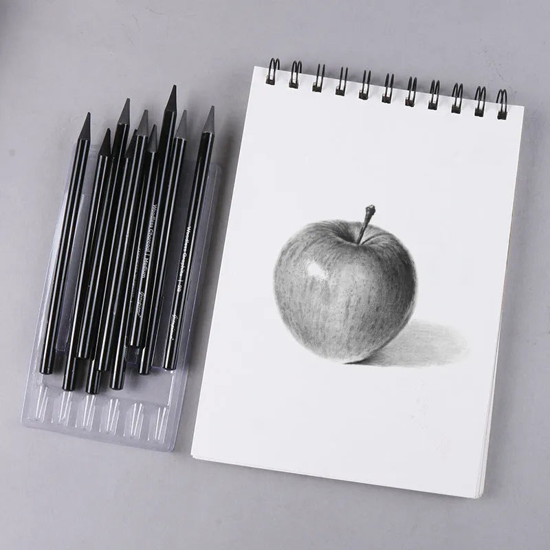 Set of six graphite and three carbonised drawing pencils with wooden casings on a white suction card.