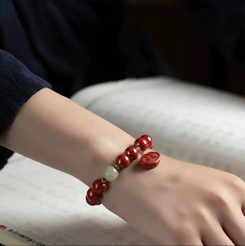 Red cinnabar bracelet with emperor sandstone carving featuring Ping An Fu Lu characters