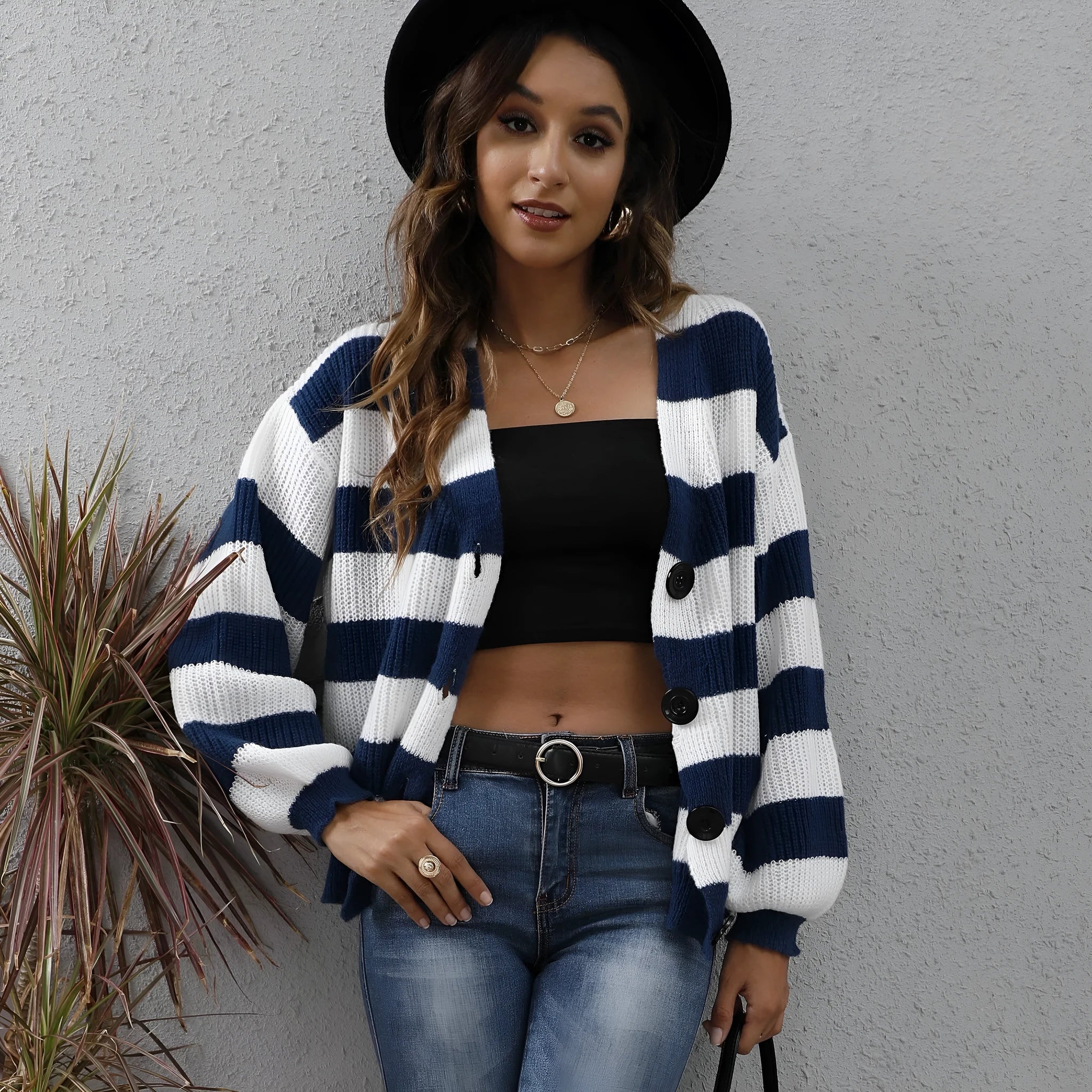 Blue and black striped women's cardigan sweater with button front and regular sleeves.