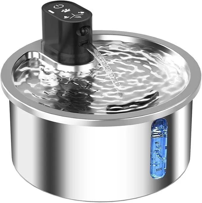 Stainless steel heated pet water fountain with white control base on a wooden floor.