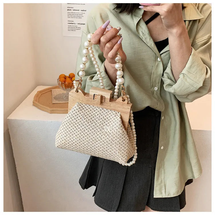 Women's straw shoulder bag with woven pearl chain detail and multiple internal compartments