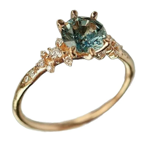 Gold-coloured geometric claw fashion ring with micro-inlaid zircon stone on a hand.
