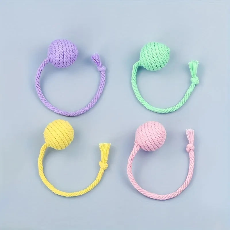 Colourful cat toy ball with attached rope and internal bell in green, pink, purple, and yellow options