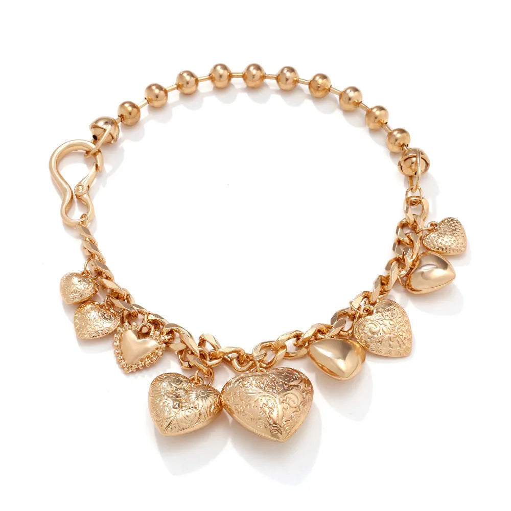 Exaggerated carved heart-shaped pendant necklace on an adjustable metal chain, shown in a gold colour finish.