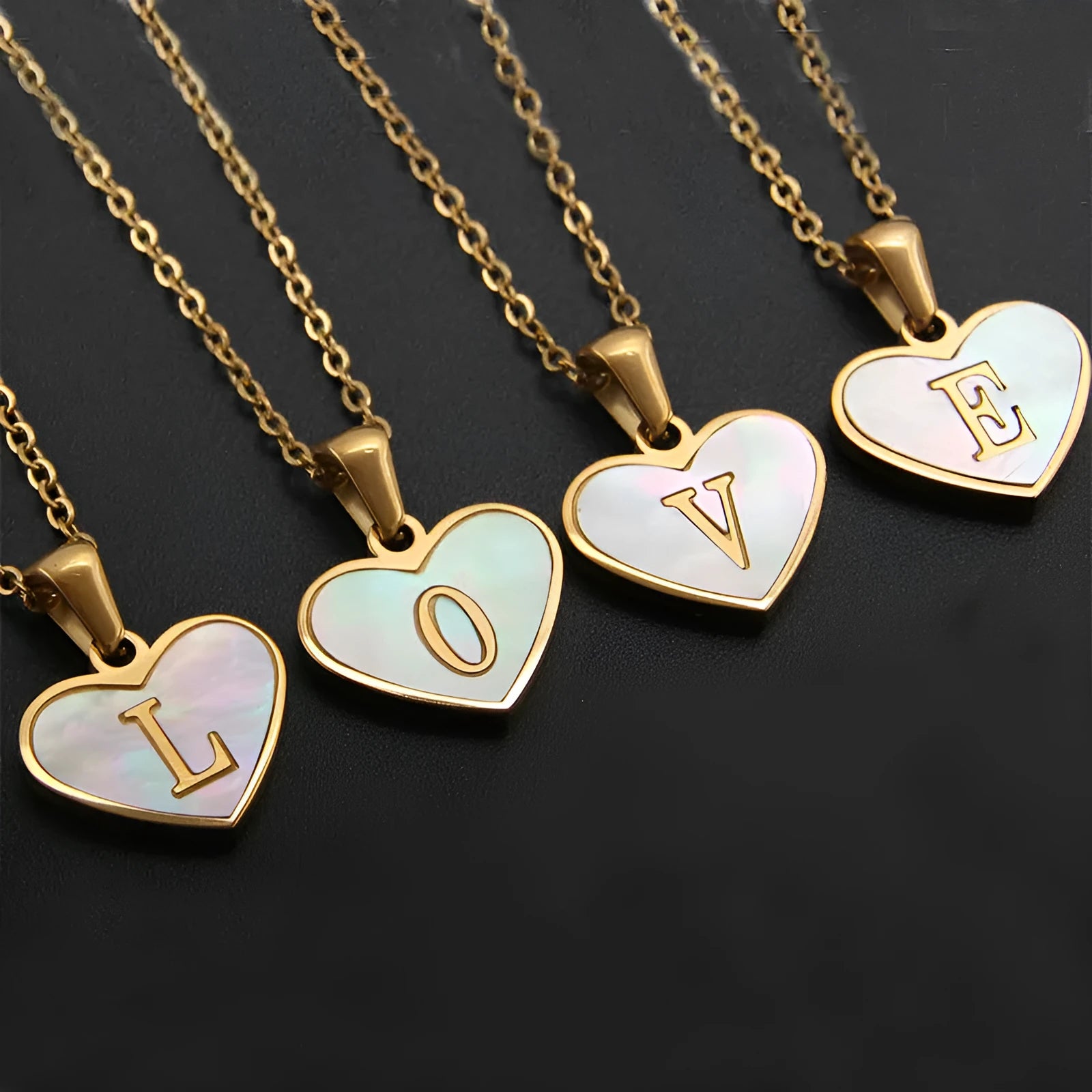 Gold plated chain necklace with a white shell heart-shaped pendant personalised with a single letter initial.