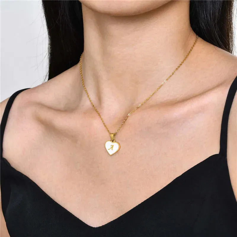 Gold plated chain necklace with a white shell heart-shaped pendant personalised with a single letter initial.