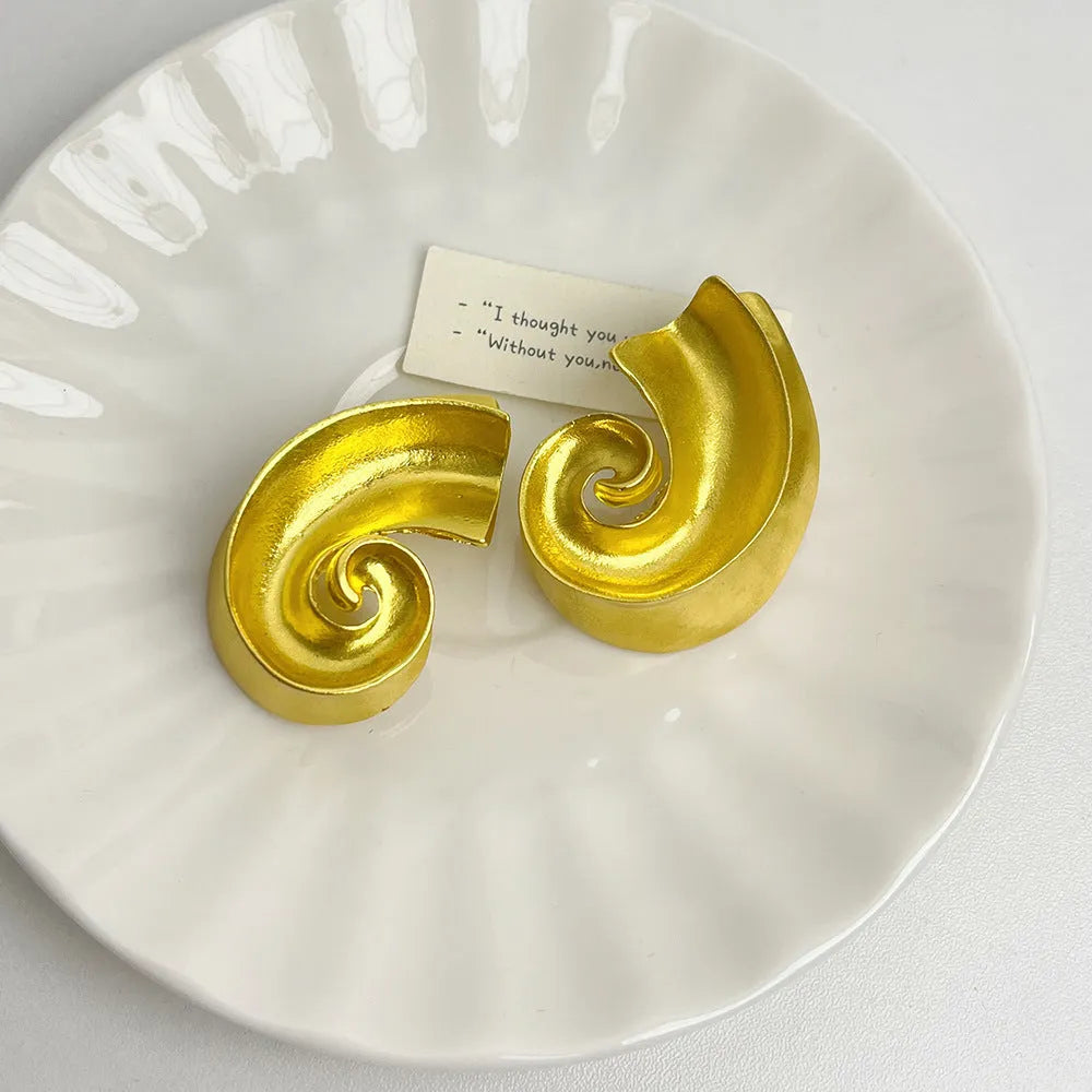 Geometric retro ear studs in gold and silver colours measuring 5cm with alloy construction