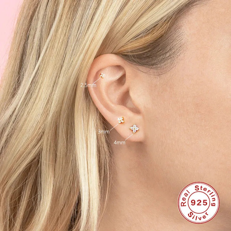 S925 sterling silver stud earrings with small petal-shaped crystal flowers in gold or platinum finish.