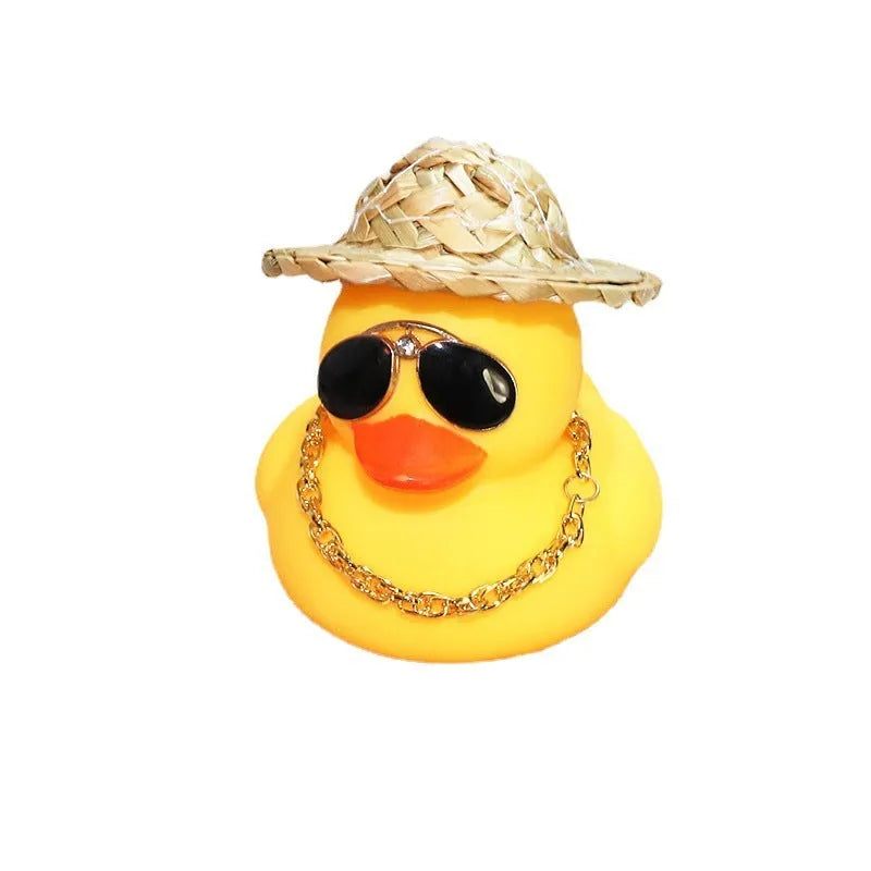 Yellow cartoon duck with straw hat car ornament on dashboard with sunglasses accessory