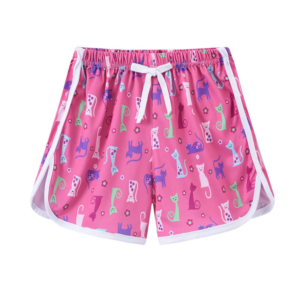 Children's colourful polyester shorts with elastic waistband, showing patterns like stripes, pineapples, and kittens.