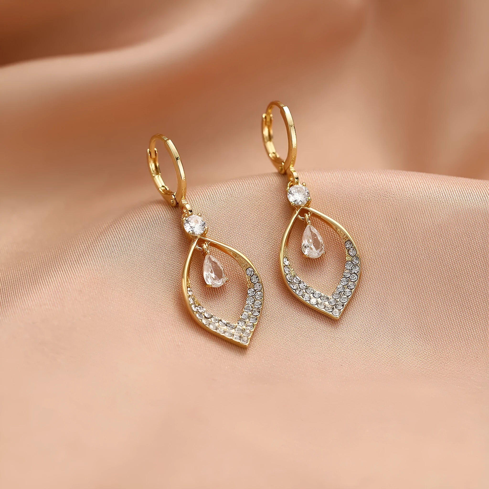 Women's gold and silver water drop tassel earrings made from zircon and copper.