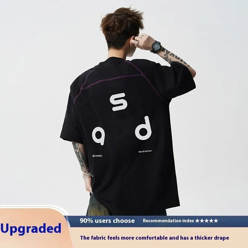 Loose fit black cotton t-shirt with letter print graphic on front, short sleeves, and round neck.