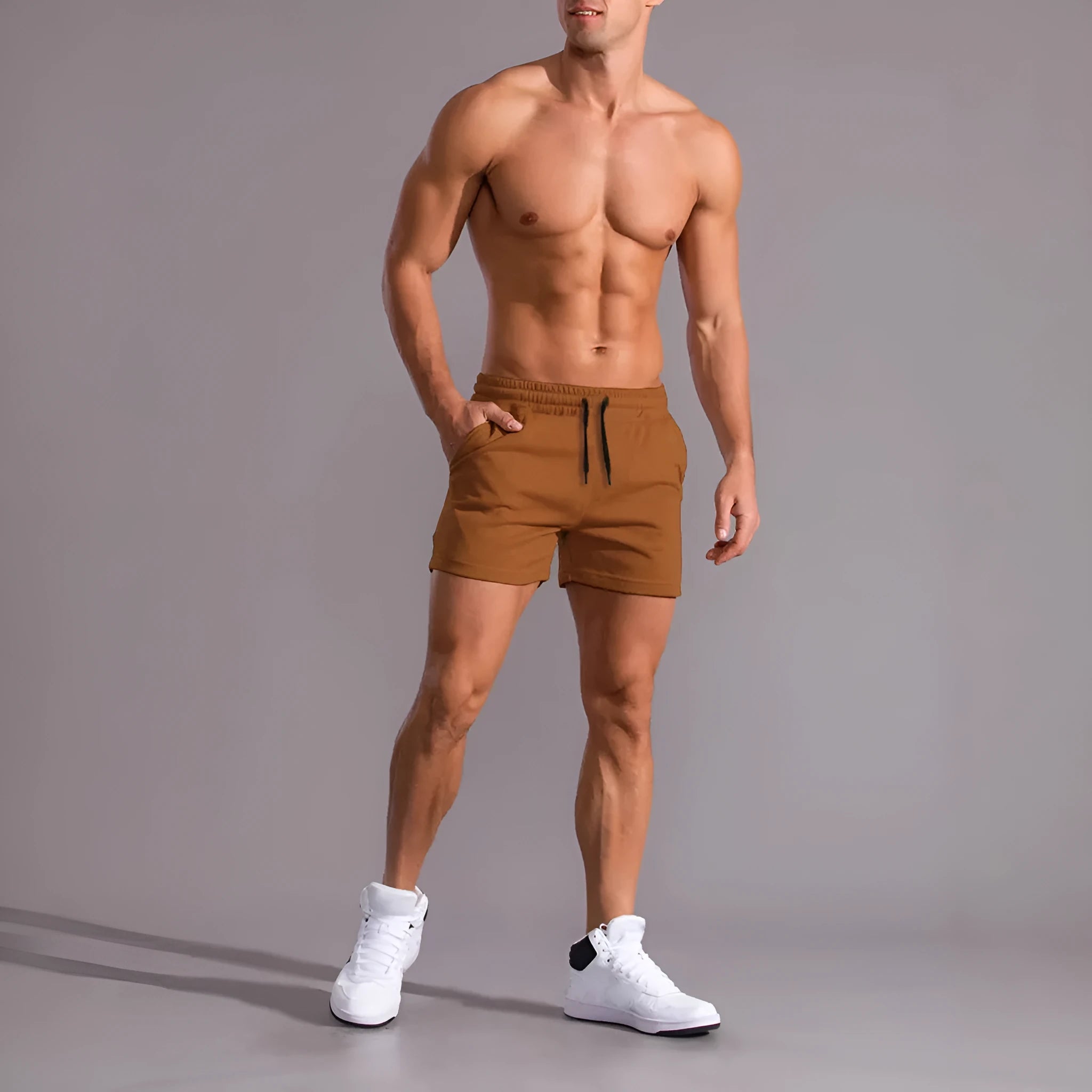 Pack of three men's solid colour drawstring shorts in loose fit on a plain background.
