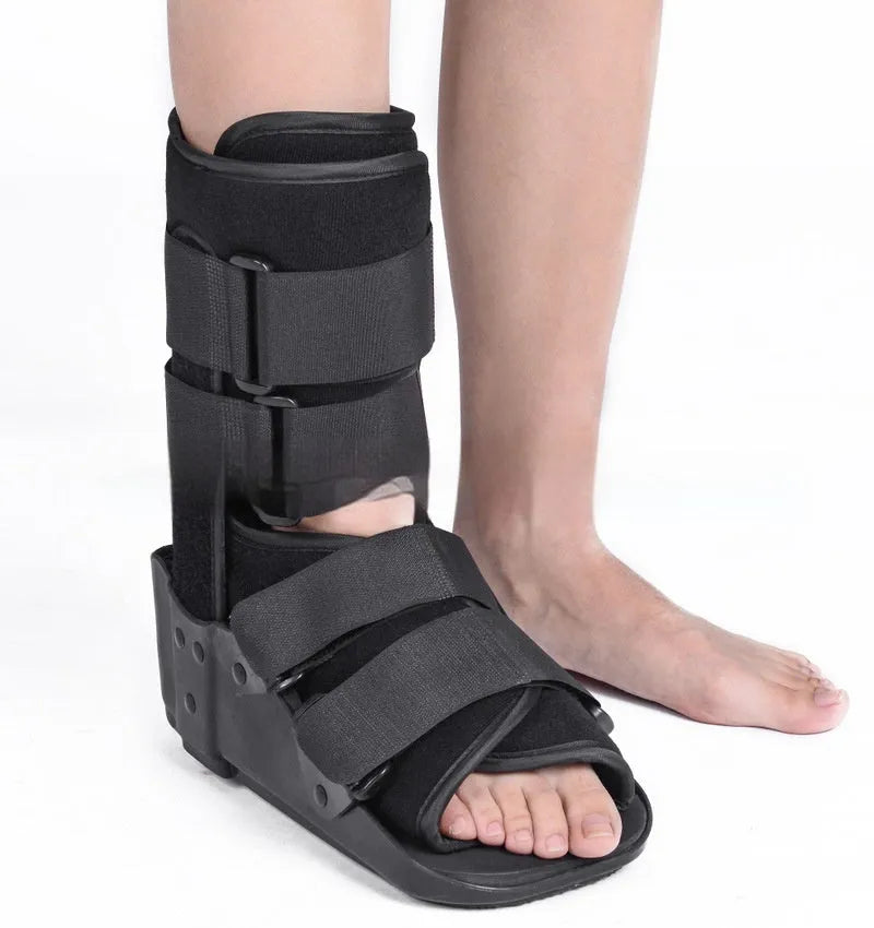 Grey and black Achilles tendon rehabilitation boot with plastic shell, adjustable straps, and rubber sole.