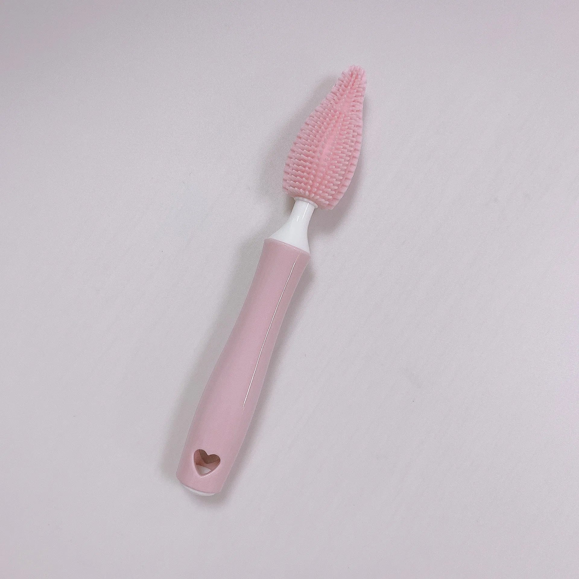 Baby bottle brush set with silicone bristles and a small straw cleaning brush in pink, blue, and yellow colours.