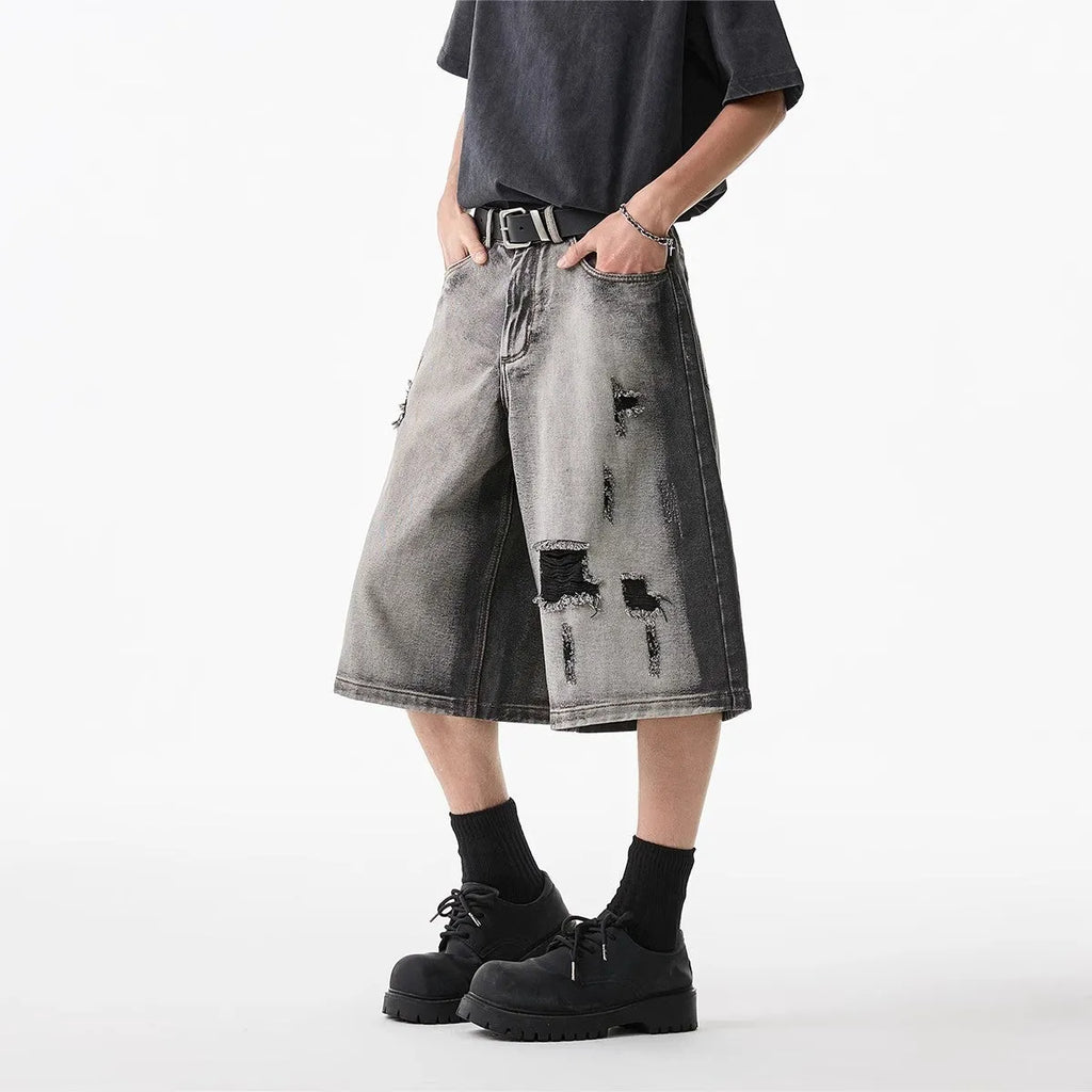 Grey distressed denim shorts with water washed finish and loose retro fit
