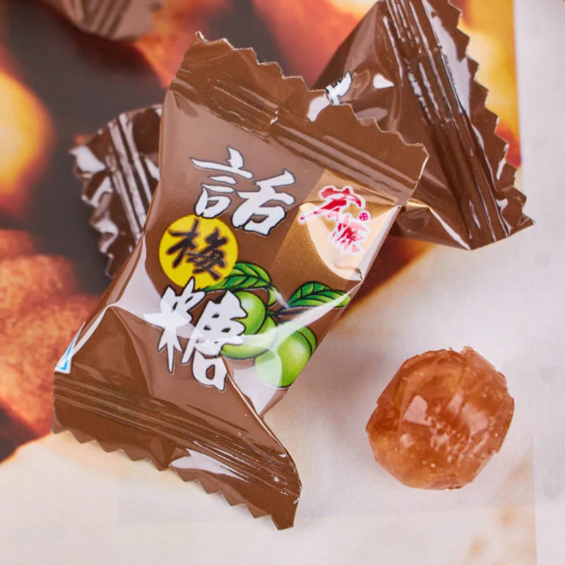 Assorted hard candies in plum, guava, and tangerine peel flavours in a bag.