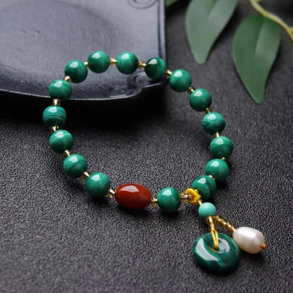 Natural green malachite and red agate barrel bead bracelet on wrist, bead size 7-8mm.
