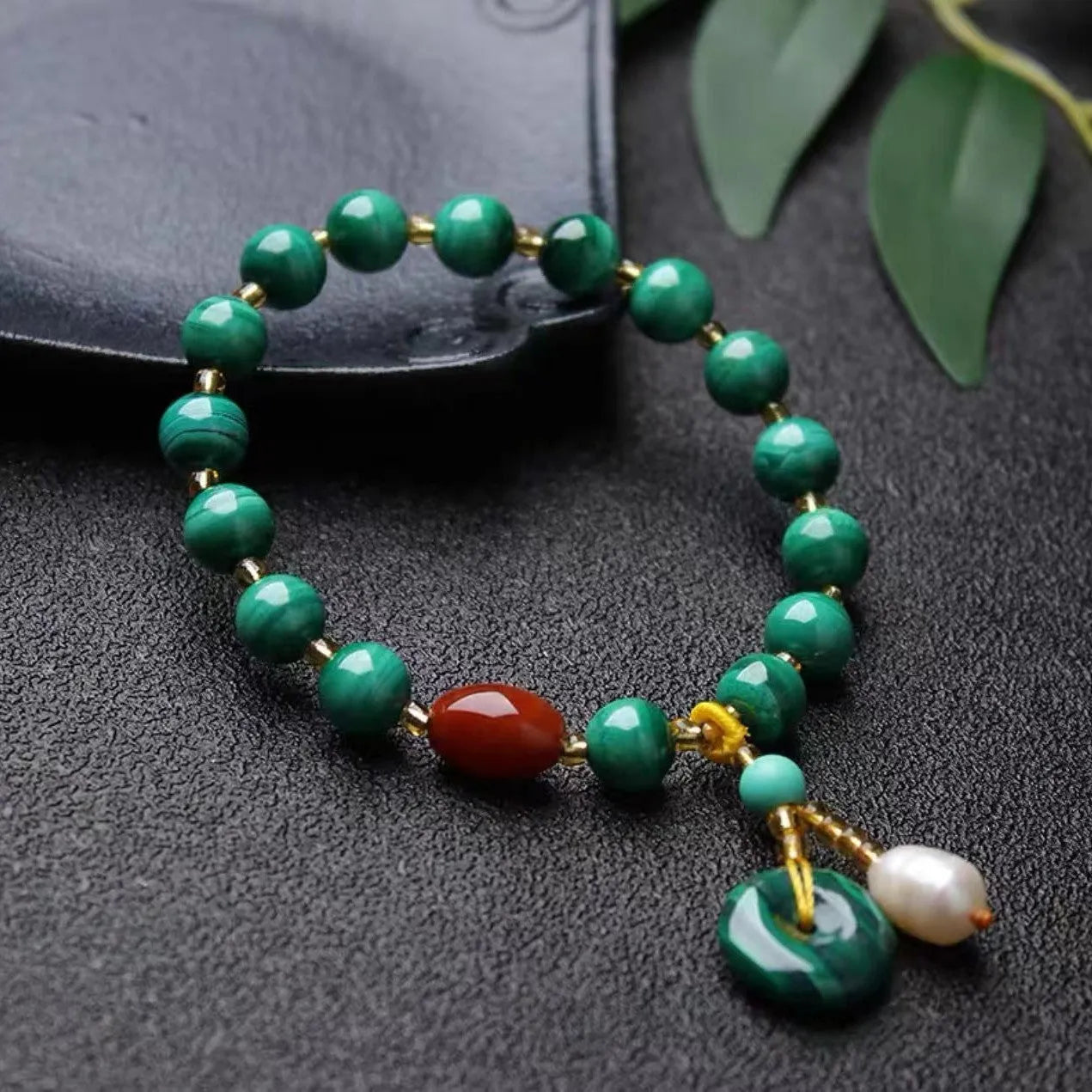 Natural green malachite and red agate barrel bead bracelet on wrist, bead size 7-8mm.